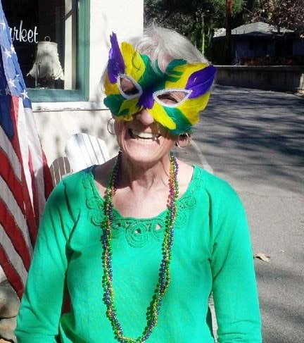 Sierra Madre Kiwanis member Joy Barry celebrated Mardi‎ Gras at Mary's Market with friends 